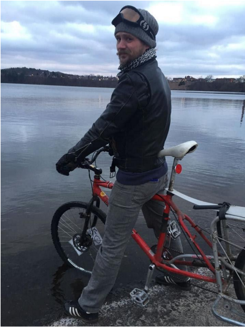 Kneeland with his bicycle on Lake Menomin.