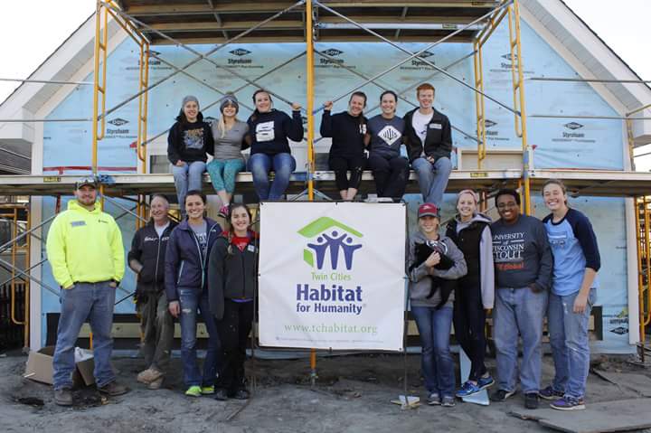 Students of Habitat for Humanity gather in front of their work done in Minneapolis